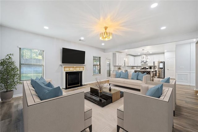 living room featuring light wood-type flooring and a chandelier