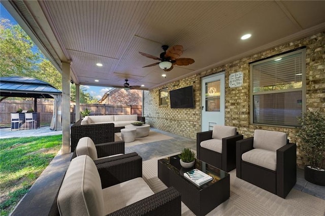 view of patio featuring ceiling fan, outdoor lounge area, and a gazebo