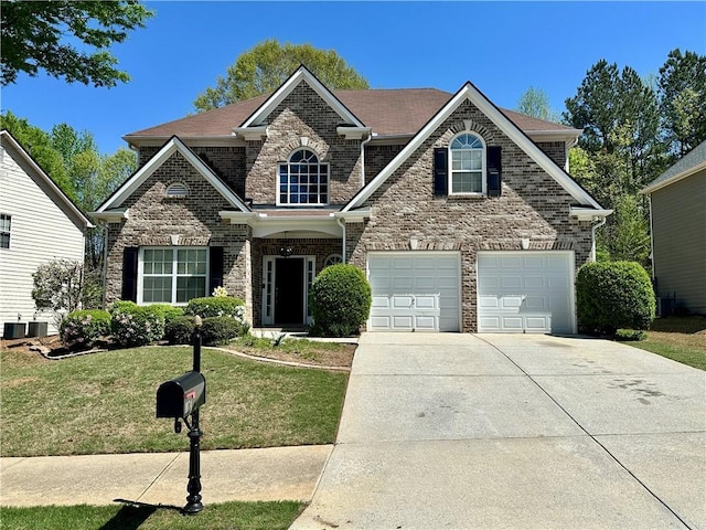 traditional-style home featuring cooling unit, a front yard, brick siding, a garage, and driveway