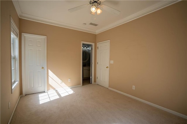 unfurnished bedroom featuring crown molding, baseboards, and light carpet