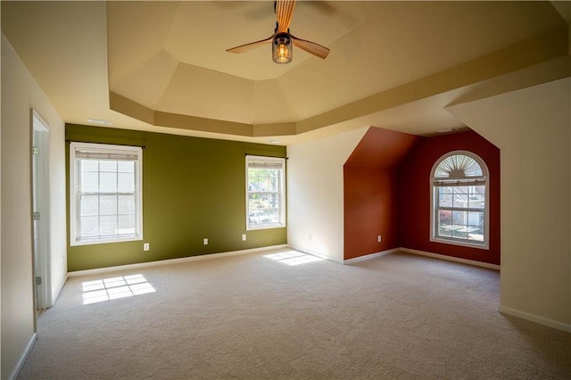 bonus room featuring ceiling fan, carpet, baseboards, and a healthy amount of sunlight