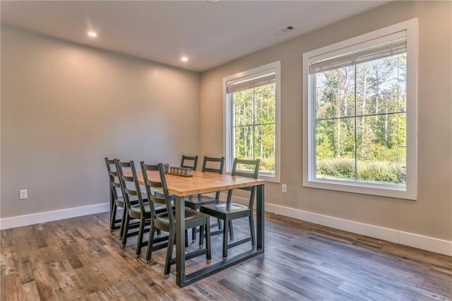 dining space with dark hardwood / wood-style floors