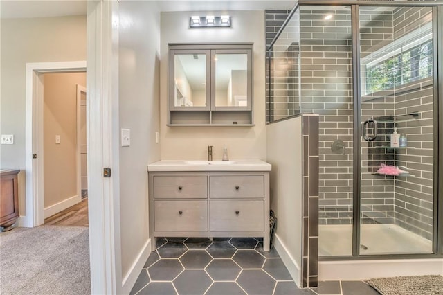 bathroom featuring vanity, tile patterned flooring, and a shower with door