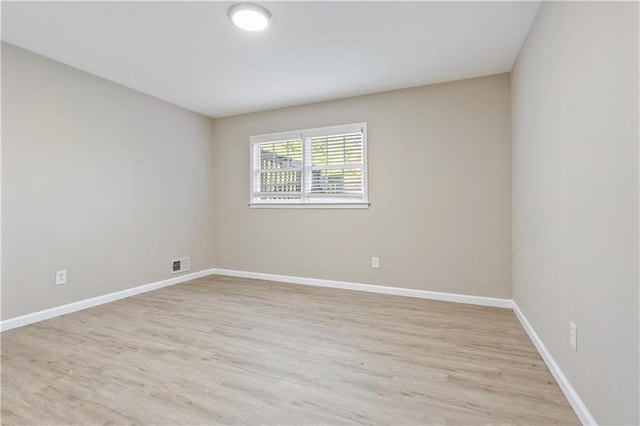 empty room with light hardwood / wood-style flooring