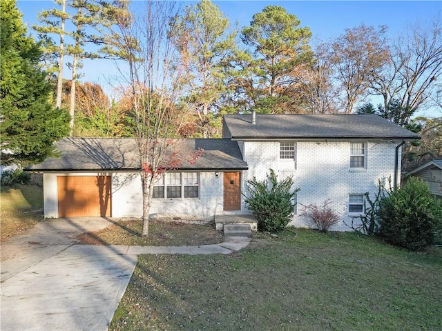 view of front of house with a garage and a front lawn