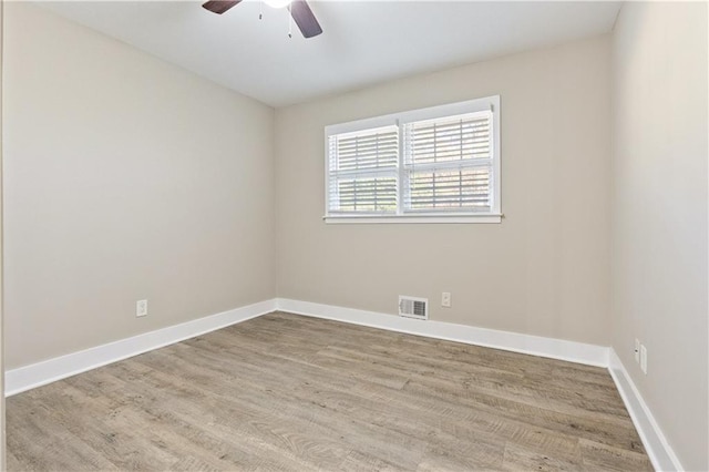 empty room featuring ceiling fan and light hardwood / wood-style flooring