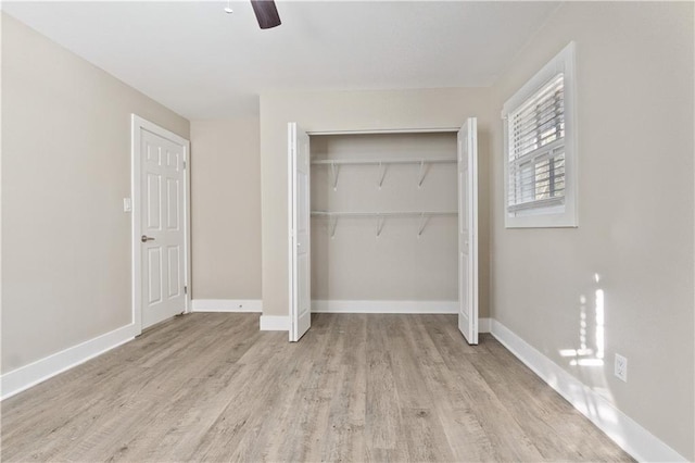 unfurnished bedroom with a closet, light hardwood / wood-style flooring, and ceiling fan