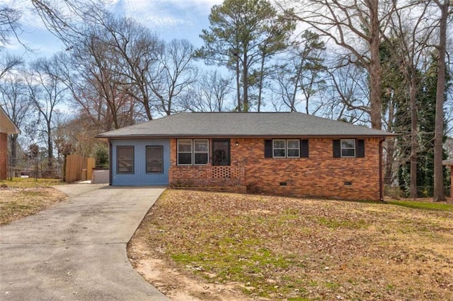 ranch-style home with crawl space, fence, concrete driveway, and brick siding