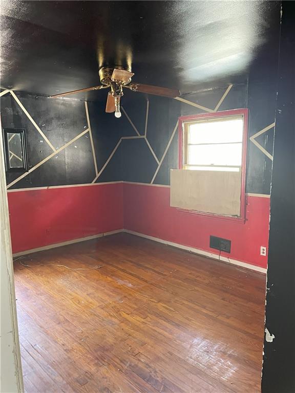 additional living space featuring visible vents, a textured ceiling, baseboards, and hardwood / wood-style floors