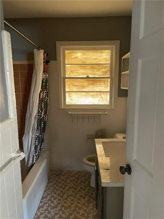 bathroom featuring vanity, tile walls, toilet, and shower / bathtub combination with curtain