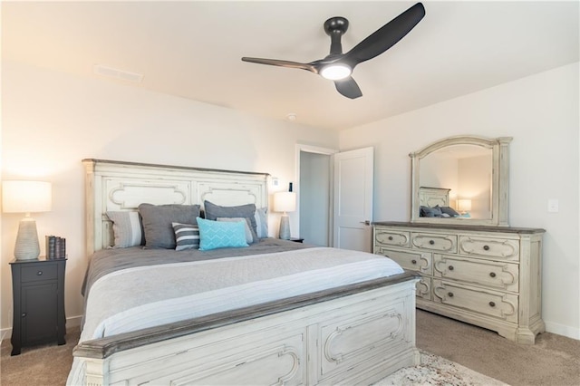 bedroom with light colored carpet, a ceiling fan, baseboards, and visible vents