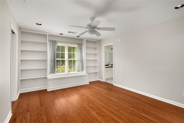 1928 Main St NW, Atlanta, GA 30318 - empty room with built in features, wood finished floors, baseboards, and a ceiling fan