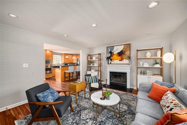 1928 Main St NW, Atlanta, GA 30318 - living room with wood finished floors, a glass covered fireplace, recessed lighting, and baseboards