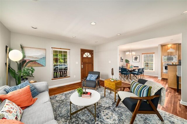 1928 Main St NW, Atlanta, GA 30318 - living room featuring a chandelier, baseboards, light wood finished floors, and recessed lighting