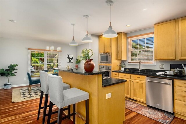 1928 Main St NW, Atlanta, GA 30318 - kitchen featuring appliances with stainless steel finishes, a sink, dark wood finished floors, a center island, and recessed lighting