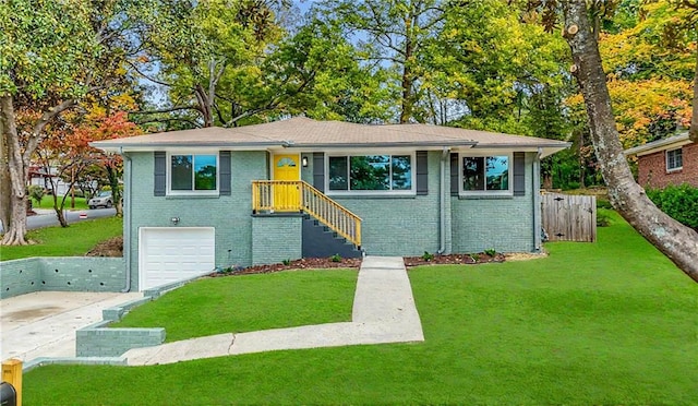 view of front of home with a front yard and a garage