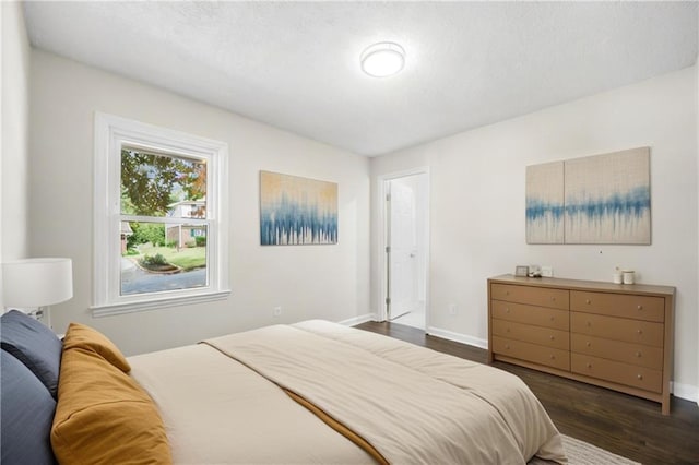 bedroom with dark wood-type flooring