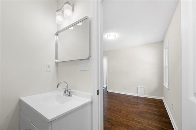 bathroom with hardwood / wood-style floors and vanity