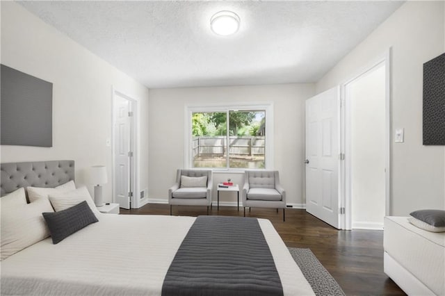 bedroom with dark hardwood / wood-style flooring