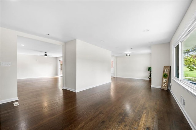 spare room featuring ceiling fan and dark wood-type flooring