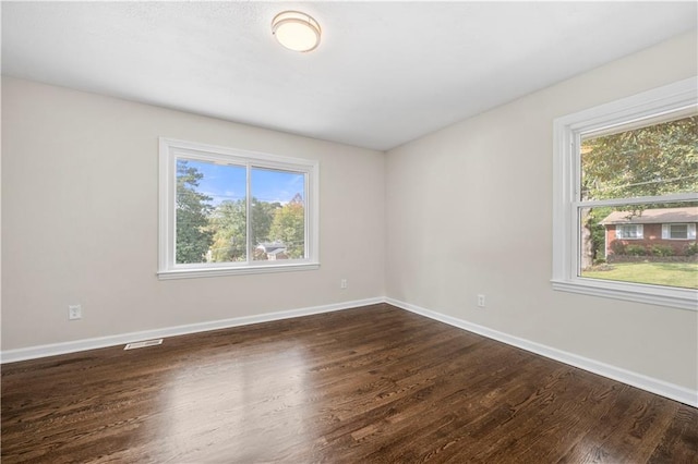 empty room with dark hardwood / wood-style floors