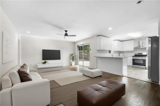 living room with dark hardwood / wood-style floors and ceiling fan