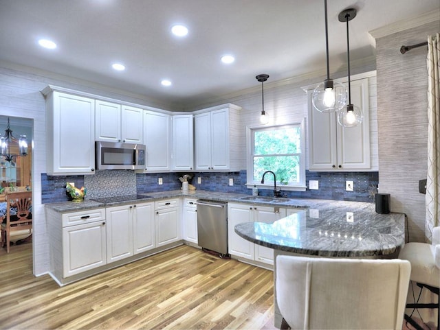 5105 Tynewick Trce NE, Roswell, GA 30075 - kitchen with stainless steel appliances, a sink, white cabinets, ornamental molding, and recessed lighting