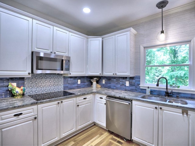 5105 Tynewick Trce NE, Roswell, GA 30075 - kitchen featuring appliances with stainless steel finishes, a sink, white cabinetry, and light wood-type flooring