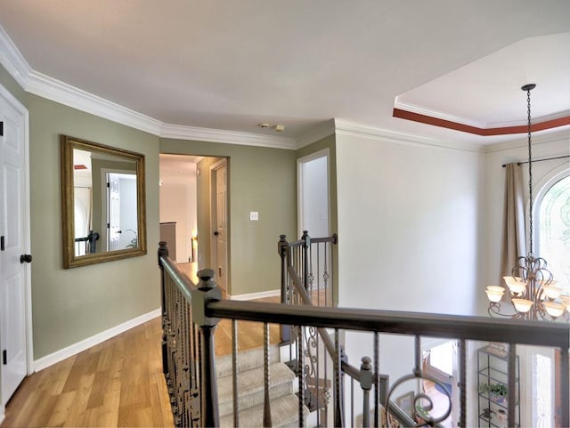 5105 Tynewick Trce NE, Roswell, GA 30075 - corridor featuring a chandelier, an upstairs landing, light wood finished floors, baseboards, and crown molding