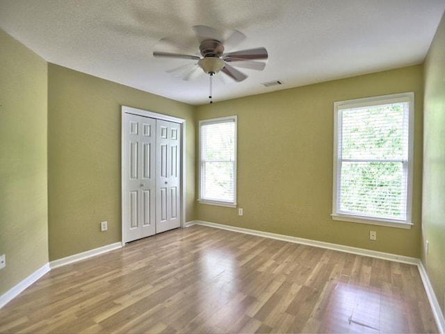 5105 Tynewick Trce NE, Roswell, GA 30075 - unfurnished bedroom featuring wood finished floors, baseboards, a closet, and ceiling fan