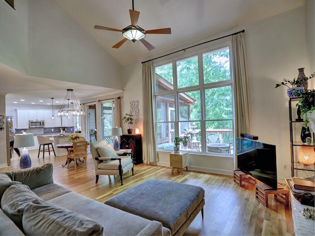 5105 Tynewick Trce NE, Roswell, GA 30075 - living room with high vaulted ceiling, ceiling fan, healthy amount of natural light, a chandelier, and light wood-style flooring