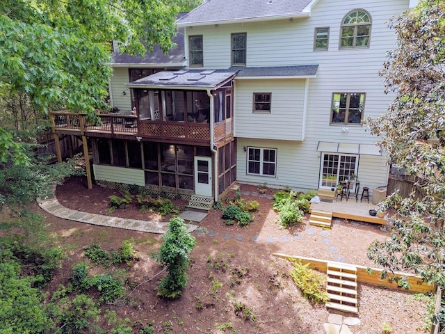 5105 Tynewick Trce NE, Roswell, GA 30075 - back of property featuring a sunroom, a deck, a shingled roof, and stairs