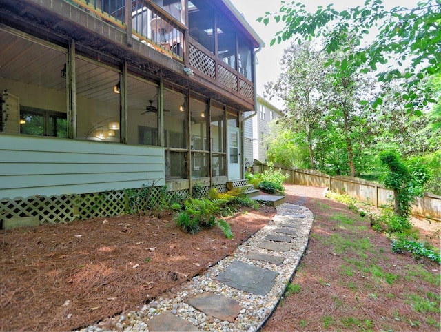 5105 Tynewick Trce NE, Roswell, GA 30075 - view of side of property with a sunroom, fence, a ceiling fan, and entry steps