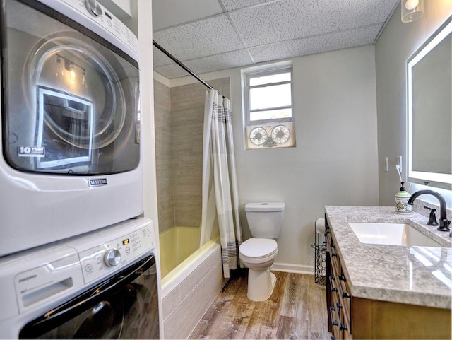 5105 Tynewick Trce NE, Roswell, GA 30075 - full bathroom with stacked washer and clothes dryer, toilet, wood finished floors, vanity, and a drop ceiling