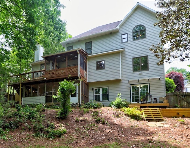 5105 Tynewick Trce NE, Roswell, GA 30075 - back of property featuring a sunroom, a deck, a chimney, and fence