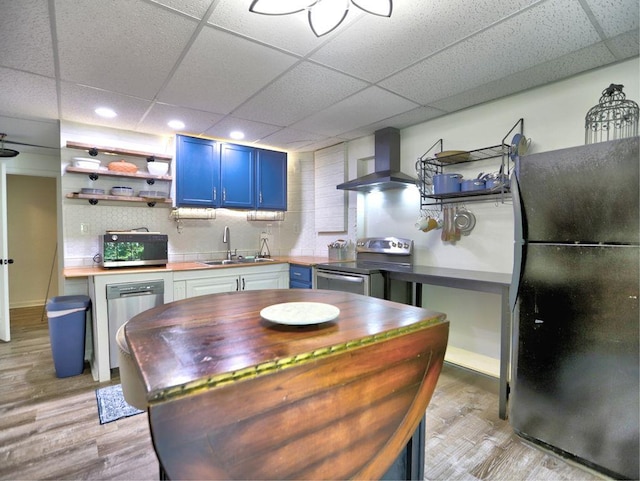 5105 Tynewick Trce NE, Roswell, GA 30075 - kitchen with stainless steel appliances, wall chimney exhaust hood, blue cabinetry, open shelves, and a paneled ceiling