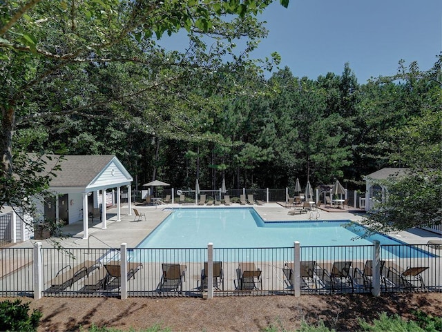 5105 Tynewick Trce NE, Roswell, GA 30075 - community pool with fence, a patio, and view of wooded area