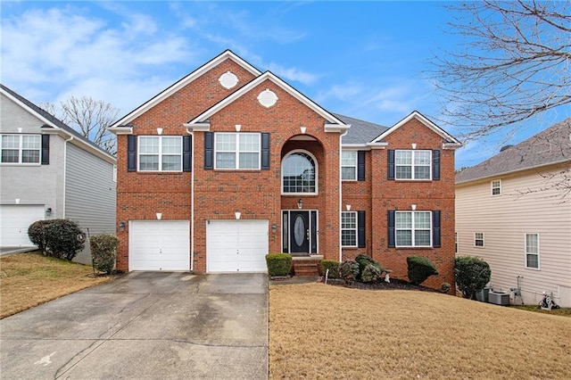 view of front of property with central AC, a garage, and a front lawn