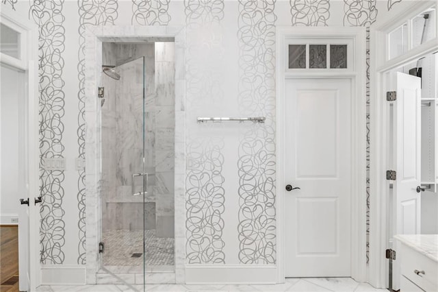 full bath featuring a marble finish shower and marble finish floors