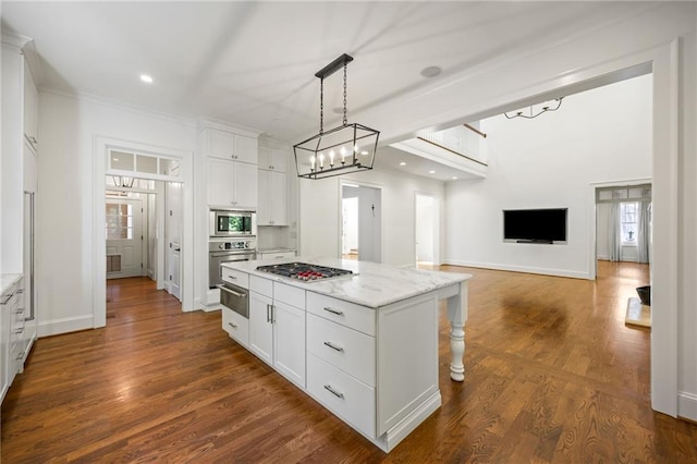 kitchen with appliances with stainless steel finishes, a warming drawer, a center island, white cabinetry, and recessed lighting