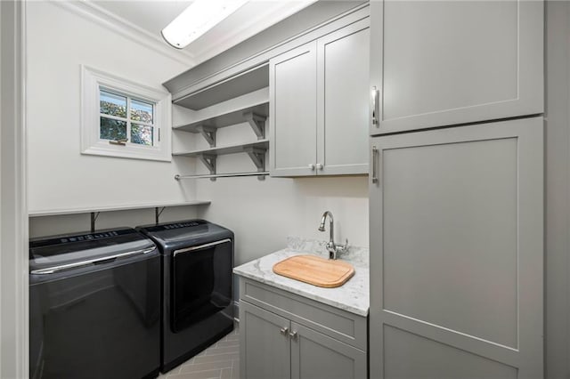 clothes washing area with independent washer and dryer, cabinet space, and ornamental molding