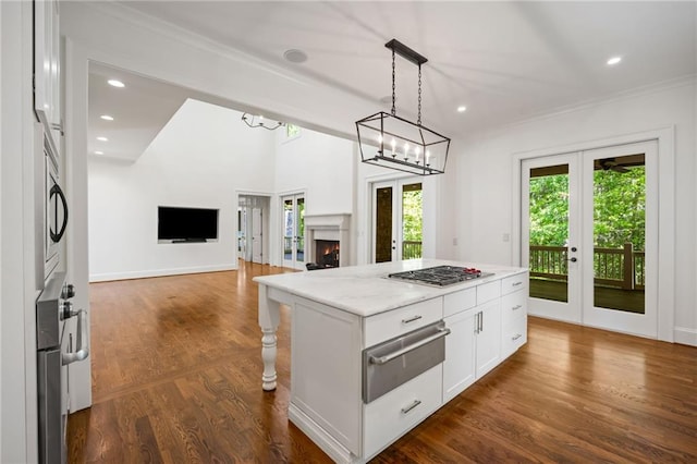 kitchen with a warming drawer, french doors, plenty of natural light, white cabinets, and recessed lighting