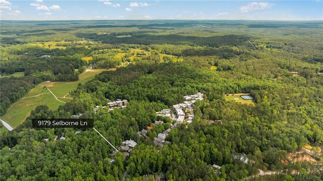 aerial overview of property's location featuring a heavily wooded area