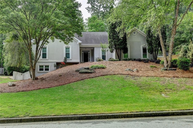 single story home featuring a front yard and stucco siding