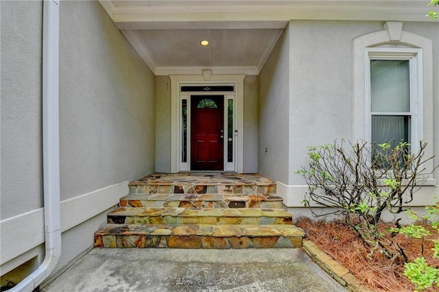 property entrance with stucco siding