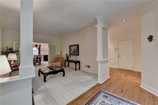 living room featuring recessed lighting, baseboards, decorative columns, wood finished floors, and visible vents