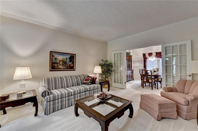 living area featuring ornamental molding, light carpet, and a chandelier