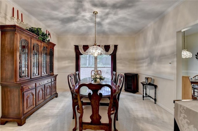 dining space featuring an inviting chandelier, baseboards, and light colored carpet