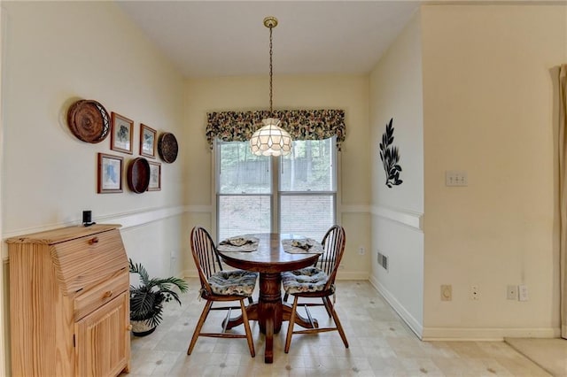 dining room featuring visible vents and baseboards