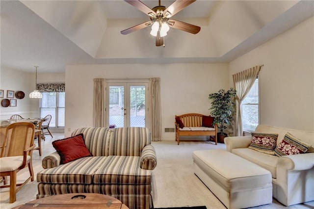 living area featuring carpet flooring, ceiling fan, and visible vents